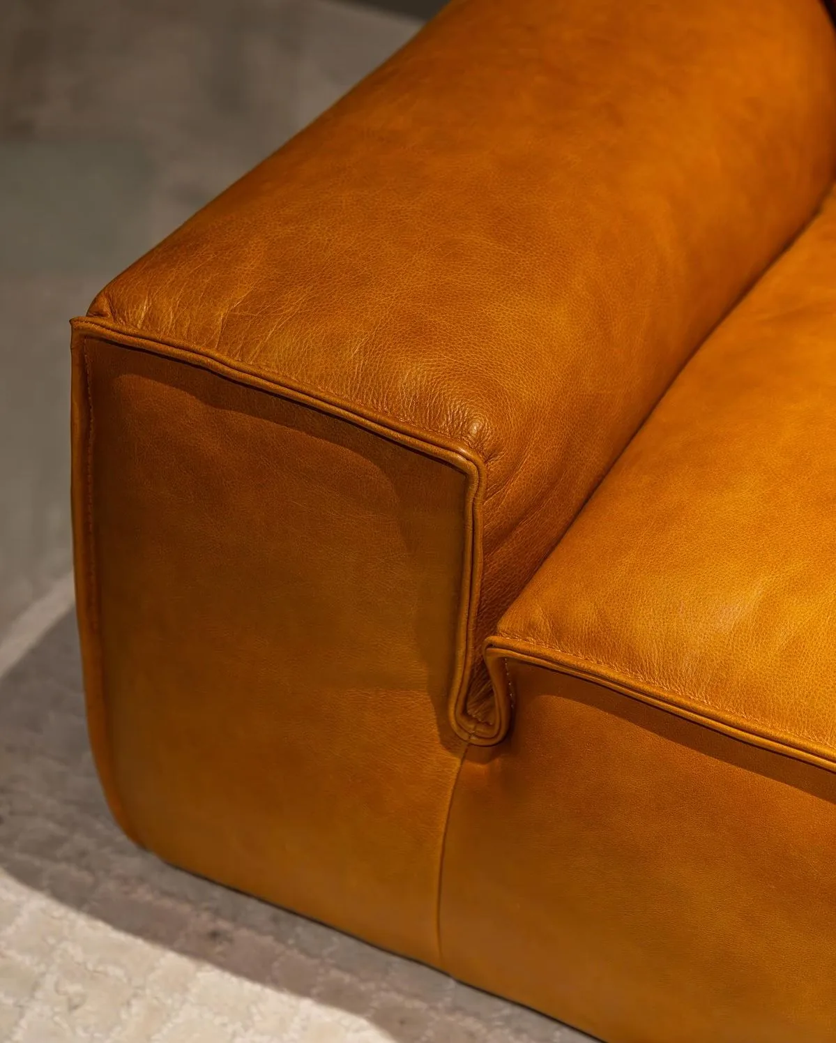 Caramel leather two-seater after recolour and hydration